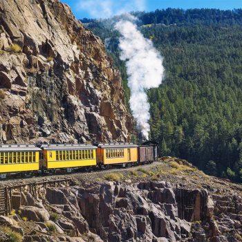 Historic steam train on a mountain pass